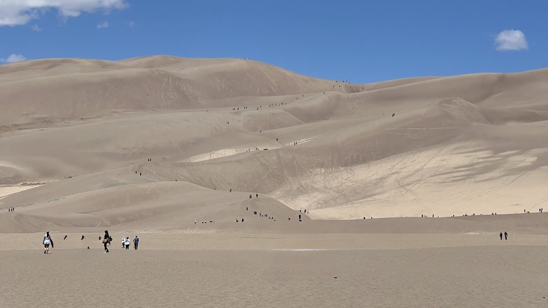 Hikers climbing the Great Sand Dunes